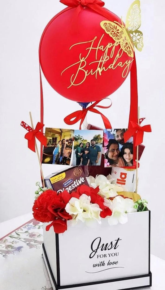 Birthday gift with photo album, chocolate, and flowers