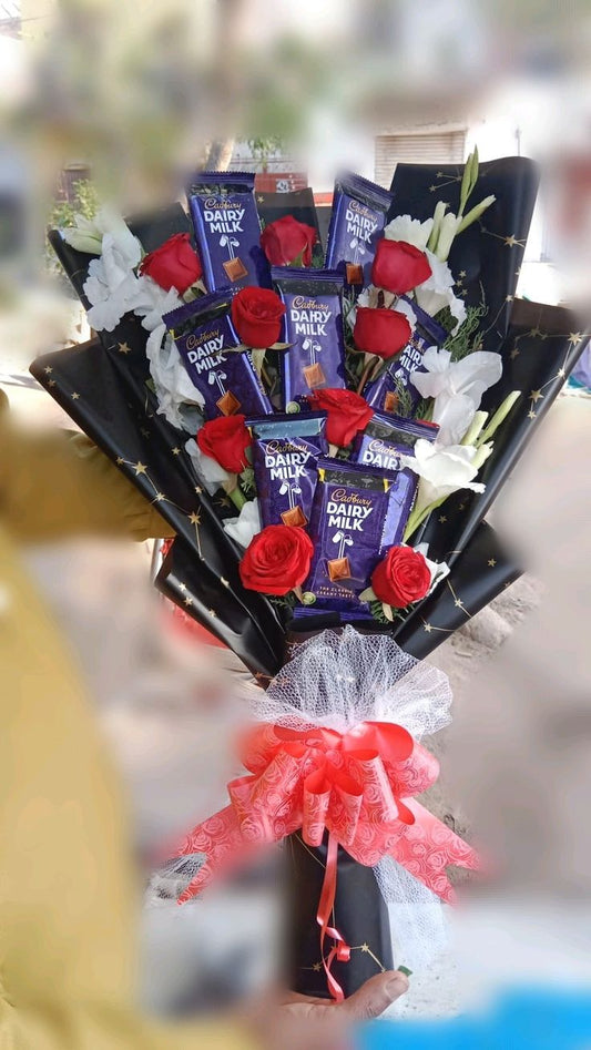 Couple gift chocolate and flower bokeh